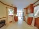 Long, galley style kitchen with wood cabinets and cream colored tile floor at 2721 Tara Dr, Monroe, NC 28112