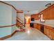 Kitchen featuring oak cabinets, countertops, modern appliances, tile floor and adjacent stairs at 2721 Tara Dr, Monroe, NC 28112