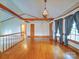 Open living room with hardwood floors, exposed wood beams, and lots of natural light at 2721 Tara Dr, Monroe, NC 28112