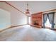 Spacious living room with brick fireplace, ceiling fan, carpet, and large windows at 2721 Tara Dr, Monroe, NC 28112
