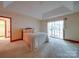 A bright and spacious bedroom has carpet flooring, a tray ceiling, and sliding glass door at 2721 Tara Dr, Monroe, NC 28112