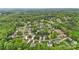 An aerial view of the home nestled in a wooded neighborhood with mature trees, well-maintained lawns, and winding streets at 2835 24Th Street Ne Dr, Hickory, NC 28601