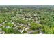 An aerial shot of a house in a leafy neighborhood, boasting mature trees and well-kept gardens, creating a serene environment at 2835 24Th Street Ne Dr, Hickory, NC 28601