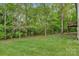 Backyard view with lush greenery and trees, showing the home's outdoor space at 2835 24Th Street Ne Dr, Hickory, NC 28601