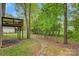 Backyard featuring mature trees, a stone pathway, and a view of the wooden deck at 2835 24Th Street Ne Dr, Hickory, NC 28601
