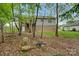 Backyard featuring a deck, fire pit and lush greenery, perfect for outdoor living at 2835 24Th Street Ne Dr, Hickory, NC 28601