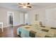 A light-filled bedroom featuring hardwood floors, a quilted bedspread, and access to the ensuite bathroom and closet at 2835 24Th Street Ne Dr, Hickory, NC 28601