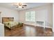 Bright bedroom with wood floors, large window, a ceiling fan, and a desk at 2835 24Th Street Ne Dr, Hickory, NC 28601