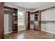 Spacious walk-in closet with built-in shelving, drawers, and hardwood floors at 2835 24Th Street Ne Dr, Hickory, NC 28601