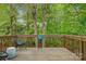 Wooden deck with chairs and a lush green forest view, perfect for outdoor entertaining at 2835 24Th Street Ne Dr, Hickory, NC 28601
