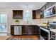 Beautiful kitchen with dark wood cabinets, stainless steel appliances, and wood floors at 2835 24Th Street Ne Dr, Hickory, NC 28601