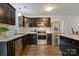 Well-lit kitchen with stainless steel appliances, dark cabinets, and sleek countertops at 2835 24Th Street Ne Dr, Hickory, NC 28601
