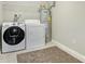 A laundry room with washer, dryer, water heater and storage shelving at 2835 24Th Street Ne Dr, Hickory, NC 28601