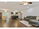 Open-concept living room showcases hardwood floors, a comfortable gray couch, and a view into the modern kitchen at 2835 24Th Street Ne Dr, Hickory, NC 28601