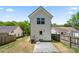 Rear view showcasing a backyard, white siding, and a concrete patio for outdoor enjoyment at 3205 Morning Dr, Charlotte, NC 28208