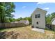 Exterior of the home showing a well sized backyard, white siding, and a concrete patio area at 3205 Morning Dr, Charlotte, NC 28208