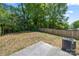 Spacious backyard featuring a lawn, trees, fence, and a concrete patio area for relaxing at 3205 Morning Dr, Charlotte, NC 28208