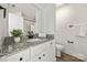 Bright bathroom featuring granite countertops, black fixtures, white vanity, and decorative plant at 3205 Morning Dr, Charlotte, NC 28208