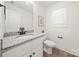 Bathroom featuring granite countertop, white vanity, toilet and framed window at 3205 Morning Dr, Charlotte, NC 28208