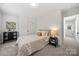 Inviting bedroom featuring a cozy bed and neutral decor with soft carpet flooring at 3205 Morning Dr, Charlotte, NC 28208