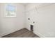 Bright, empty walk-in closet with clean, minimalist design and wood-style flooring at 3205 Morning Dr, Charlotte, NC 28208