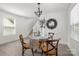 The dining area offers a chandelier and glass table near the staircase at 3205 Morning Dr, Charlotte, NC 28208