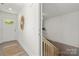 Bright entryway with plank flooring leads to stairs and features a gold sunburst mirror at 3205 Morning Dr, Charlotte, NC 28208