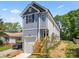 Charming two-story home boasts a gray exterior with a garage and inviting wooden steps at 3205 Morning Dr, Charlotte, NC 28208