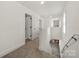 An upstairs hallway features neutral walls, carpeting, and multiple doors at 3205 Morning Dr, Charlotte, NC 28208