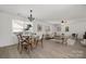 An open-concept living area with natural light highlights the dining and living areas at 3205 Morning Dr, Charlotte, NC 28208