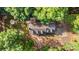 Stunning aerial view of a home nestled among mature trees, with a private driveway and backyard firepit at 328 Earl Griffin Rd, Monroe, NC 28112