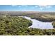 Breathtaking aerial view featuring a large lake surrounded by forest and some open fields at 328 Earl Griffin Rd, Monroe, NC 28112