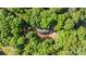 Stunning aerial shot capturing the home nestled among dense trees and lush greenery in a serene setting at 328 Earl Griffin Rd, Monroe, NC 28112