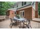 Inviting patio featuring an outdoor dining table and brick exterior at 328 Earl Griffin Rd, Monroe, NC 28112