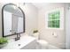 Bright bathroom featuring modern vanity, faucet, lighting and white subway tiled shower at 328 Earl Griffin Rd, Monroe, NC 28112