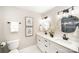 Stylish bathroom featuring double sinks, gold mirrors, and modern lighting fixtures at 328 Earl Griffin Rd, Monroe, NC 28112