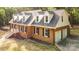 Beautiful exterior view with a two-car garage and brick facade in a serene wooded setting at 328 Earl Griffin Rd, Monroe, NC 28112
