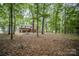 The house surrounded by mature trees providing a shady, private lot at 328 Earl Griffin Rd, Monroe, NC 28112