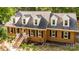 Aerial view showcasing the home's exterior with white trim, dormer windows, and a landscaped yard at 328 Earl Griffin Rd, Monroe, NC 28112