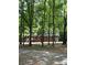 Charming brick home with black shutters and white trim, partially obscured by trees, with a long driveway at 328 Earl Griffin Rd, Monroe, NC 28112