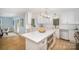 Bright eat-in kitchen with a breakfast bar, white cabinets, and stainless appliances at 328 Earl Griffin Rd, Monroe, NC 28112