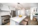 Bright kitchen features white cabinets, stainless steel appliances, and spacious island at 328 Earl Griffin Rd, Monroe, NC 28112