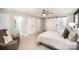 Bright main bedroom featuring a ceiling fan, accent chair, ensuite, and walk-in closets at 328 Earl Griffin Rd, Monroe, NC 28112