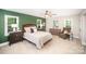 Bright main bedroom featuring a ceiling fan, accent wall, chair, and dresser at 328 Earl Griffin Rd, Monroe, NC 28112