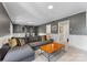 Finished basement with a sectional sofa, wood paneled walls, and exercise equipment at 3329 Winnipeg Cir, Charlotte, NC 28210