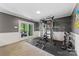 Basement workout area featuring multi gym, free weights, and access to the outdoor patio at 3329 Winnipeg Cir, Charlotte, NC 28210