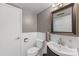 Bathroom featuring a toilet, sink, mirror, and tiled walls at 3329 Winnipeg Cir, Charlotte, NC 28210