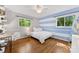 Bedroom with hardwood floors, ample sunlight, and a desk area at 3329 Winnipeg Cir, Charlotte, NC 28210