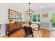 Inviting dining area features a round table, stylish sideboard, and bright window with green outdoor views at 3329 Winnipeg Cir, Charlotte, NC 28210