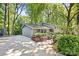 Long concrete driveway leading to a gray painted brick home surrounded by greenery at 3329 Winnipeg Cir, Charlotte, NC 28210
